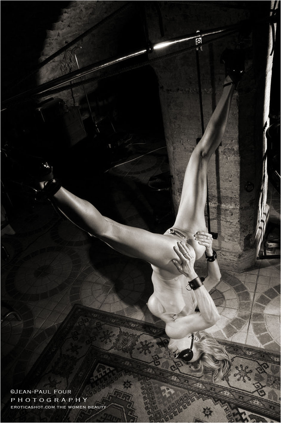 nice pict of Marie, suspended by the feet legs wide open, in the PLS cellar in Paris, sub and friend, pee girl, pisseuse, black corset and red ballet shoes, and piercings on labias, follow her on eroticashot.com, pict by Jean-Paul Four
