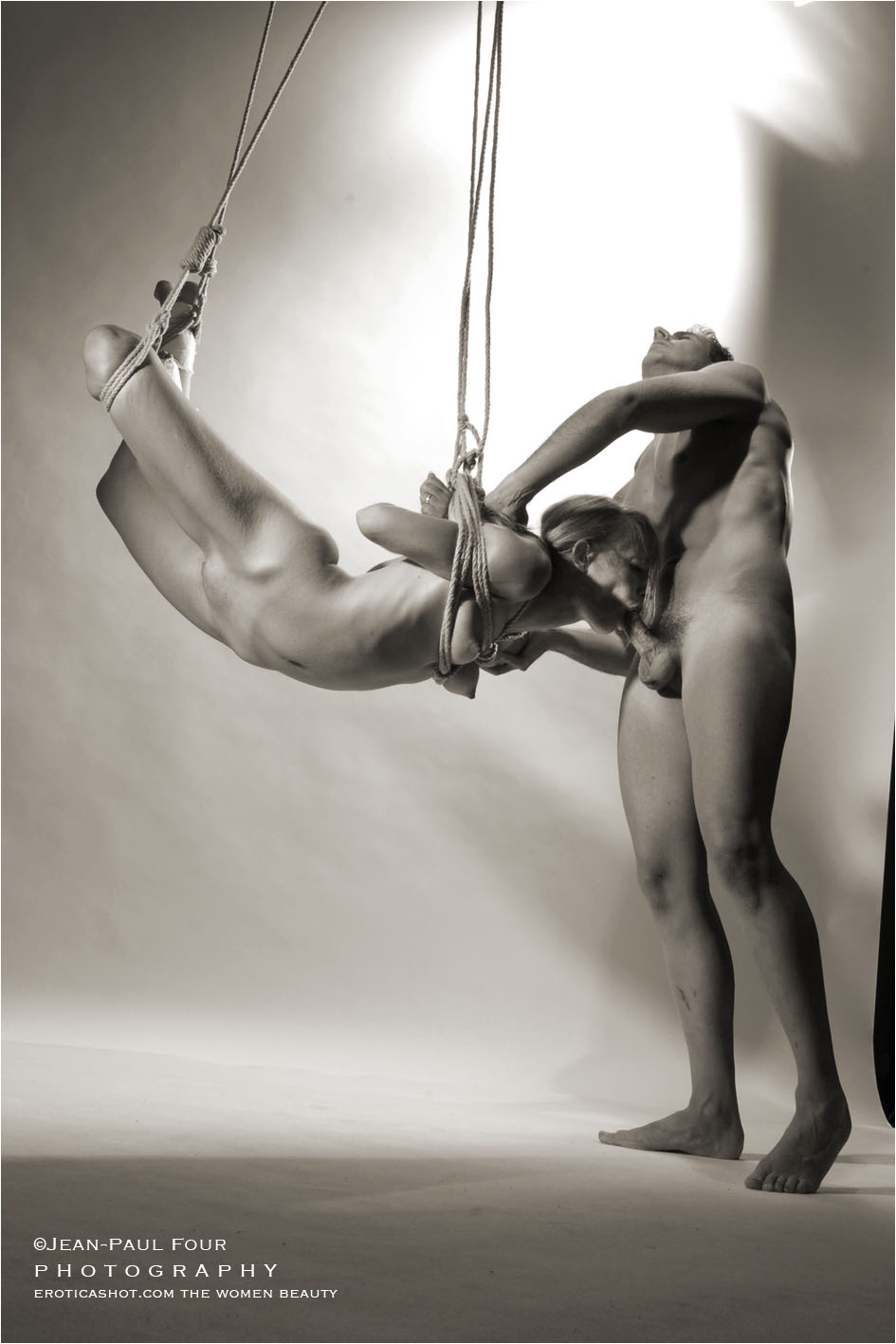 a blonde naked sucks a man naked, Melanie and O, blowjob in the air, gynecological examination, bondage, shibari blowjob, pict by Jean-Paul Four